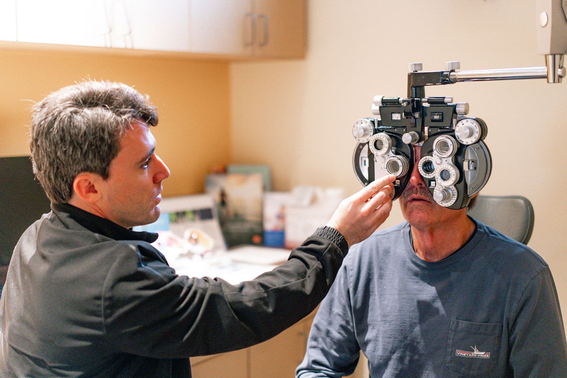 eye exam on patient using phoropter